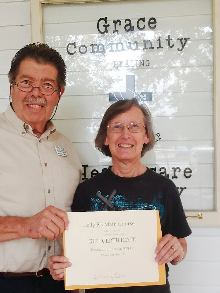 Shirley Barnett won gift certificates worth over $200 to local restaurants and eateries in Mineola in a drawing at the Iron Horse Festival by Grace Community Healthcare Ministry, presented by Director Jerry Brooks.